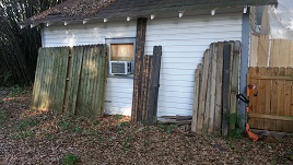 Backyard Fencing Old Panels Await Reconstruction